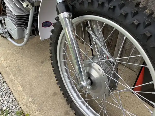 Close-up of dirt bike front tire and suspension.
