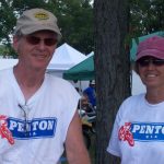 Two people in Penton shirts outdoors.