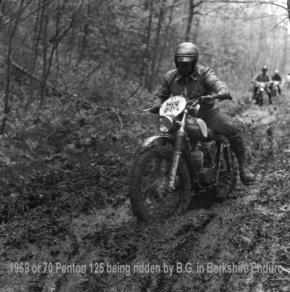 Motorcycle rider navigating muddy forest trail