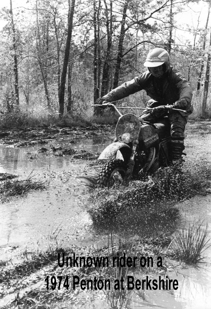 Rider on vintage Penton motorcycle through muddy terrain