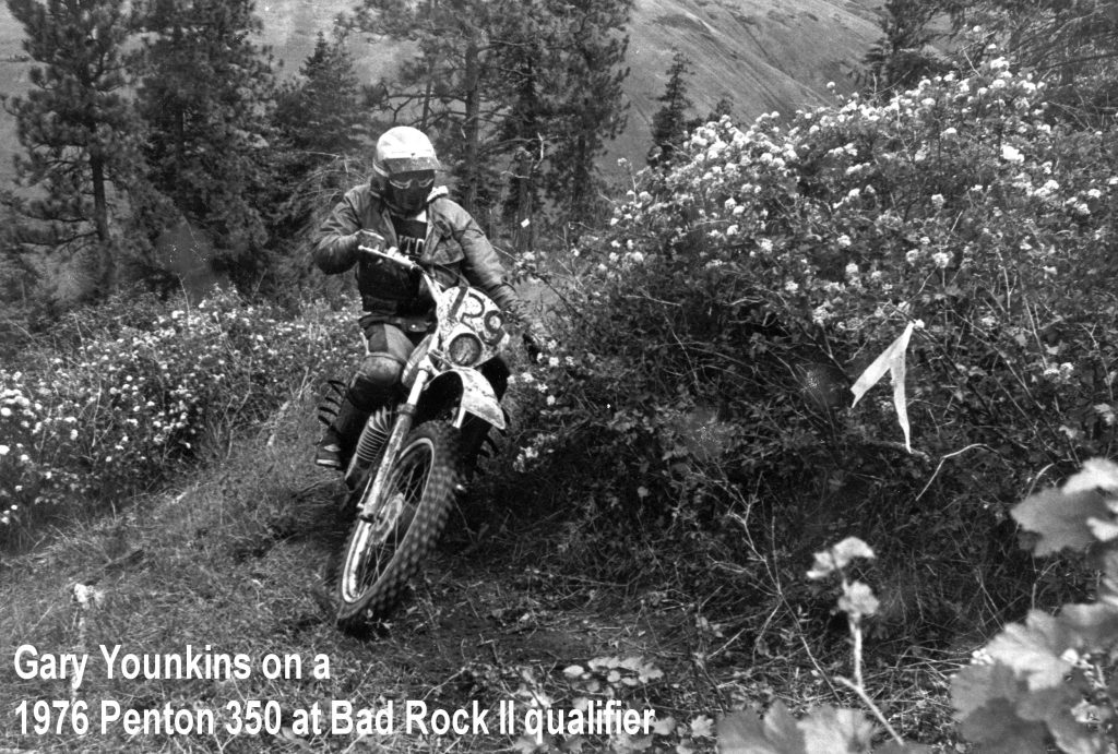 Motorcyclist riding through forest trail race