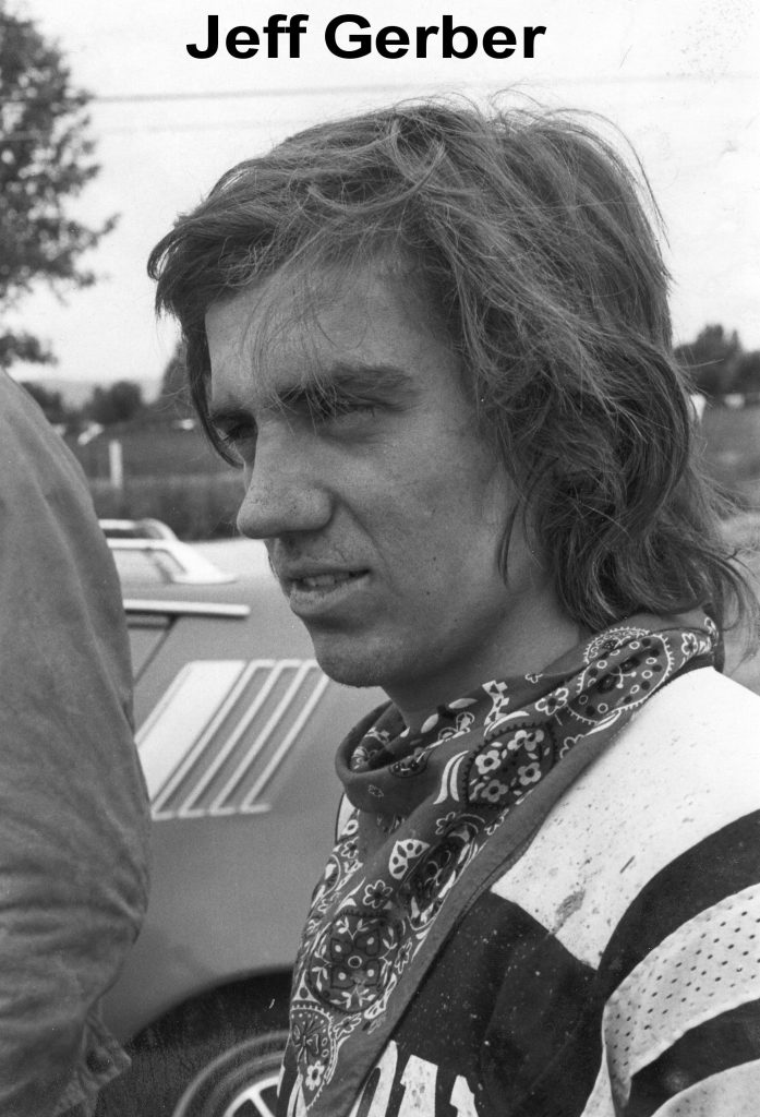 Person with scarf standing near a car