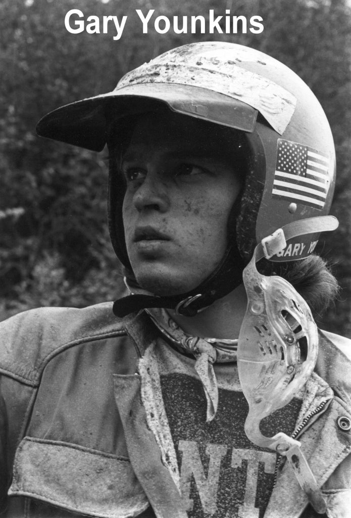Motorcyclist wearing helmet with American flag design.