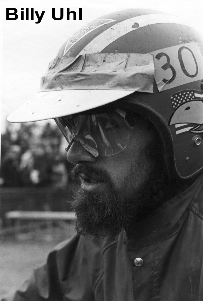 Motorcyclist wearing helmet and goggles, black and white