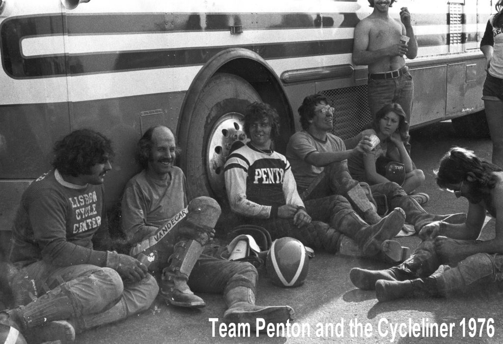 1976 motorcycle team resting by bus