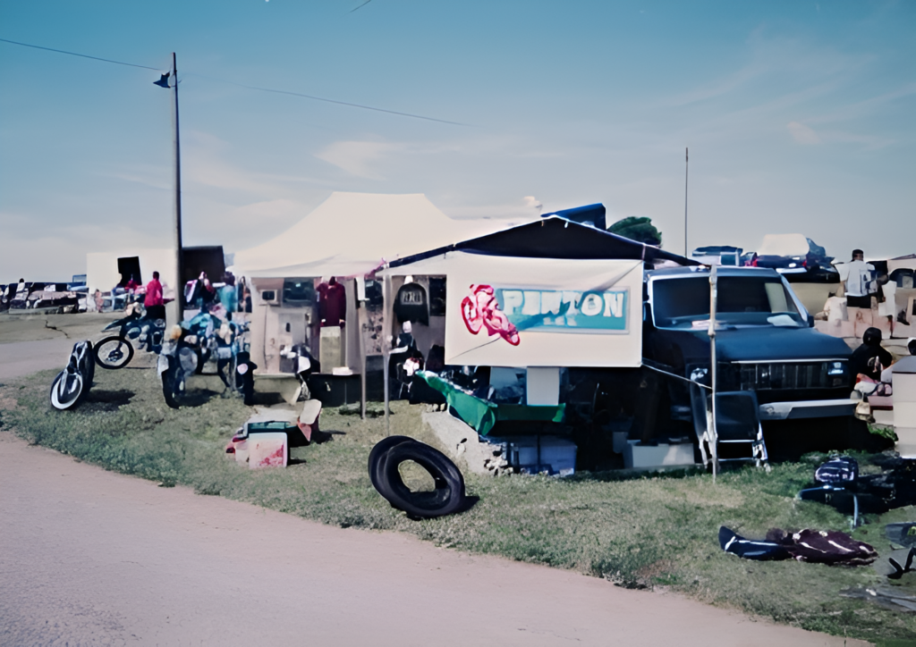 Outdoor motorcycle parts market with tents and signage