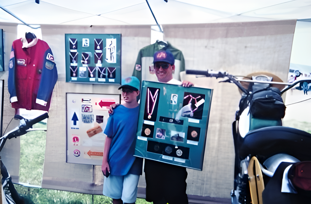 People displaying awards and motorcycle in exhibit