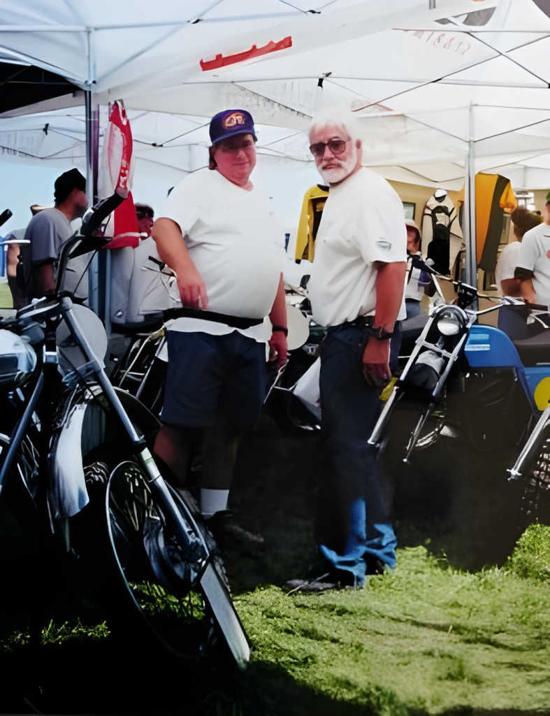 Two men at vintage motorcycle event.