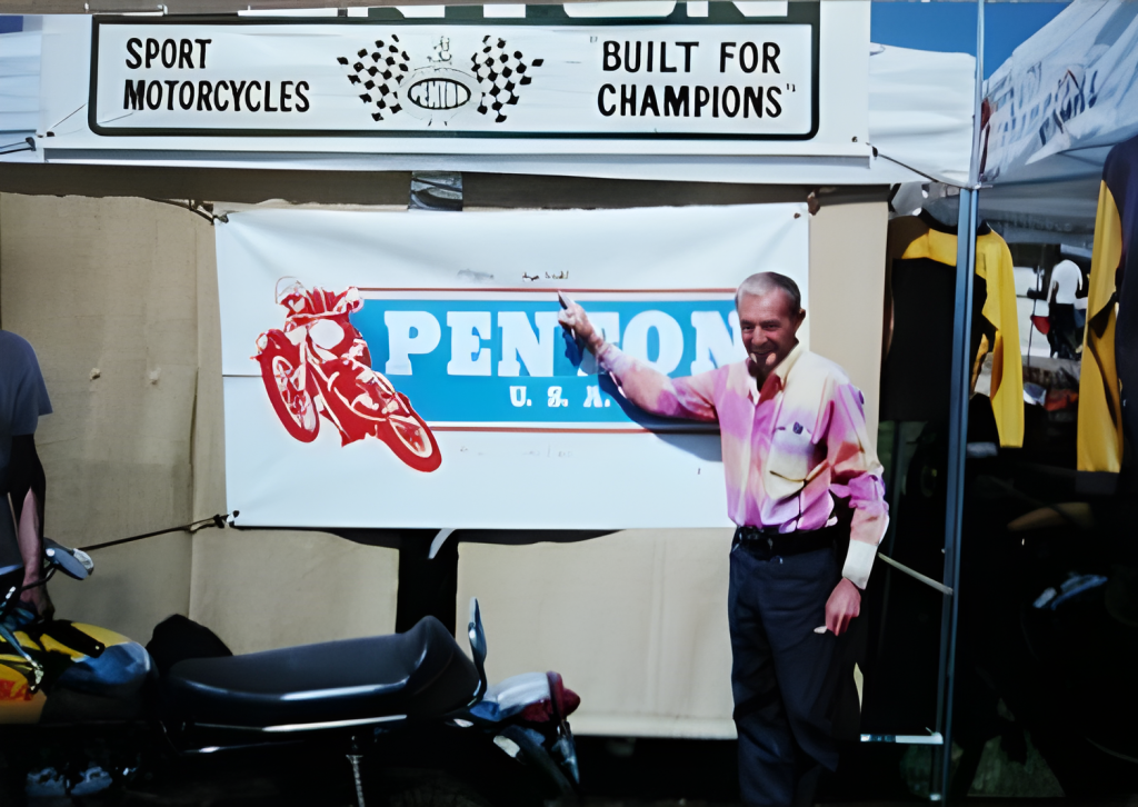 Man pointing at Penton motorcycle banner