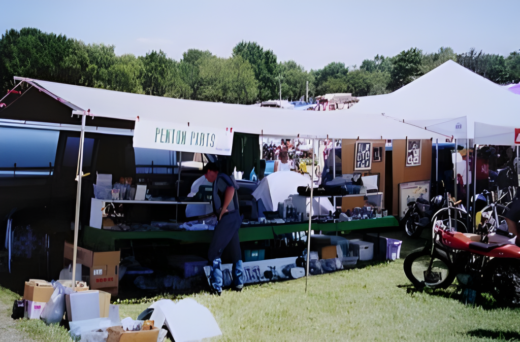 Outdoor market stall selling motorcycle parts.