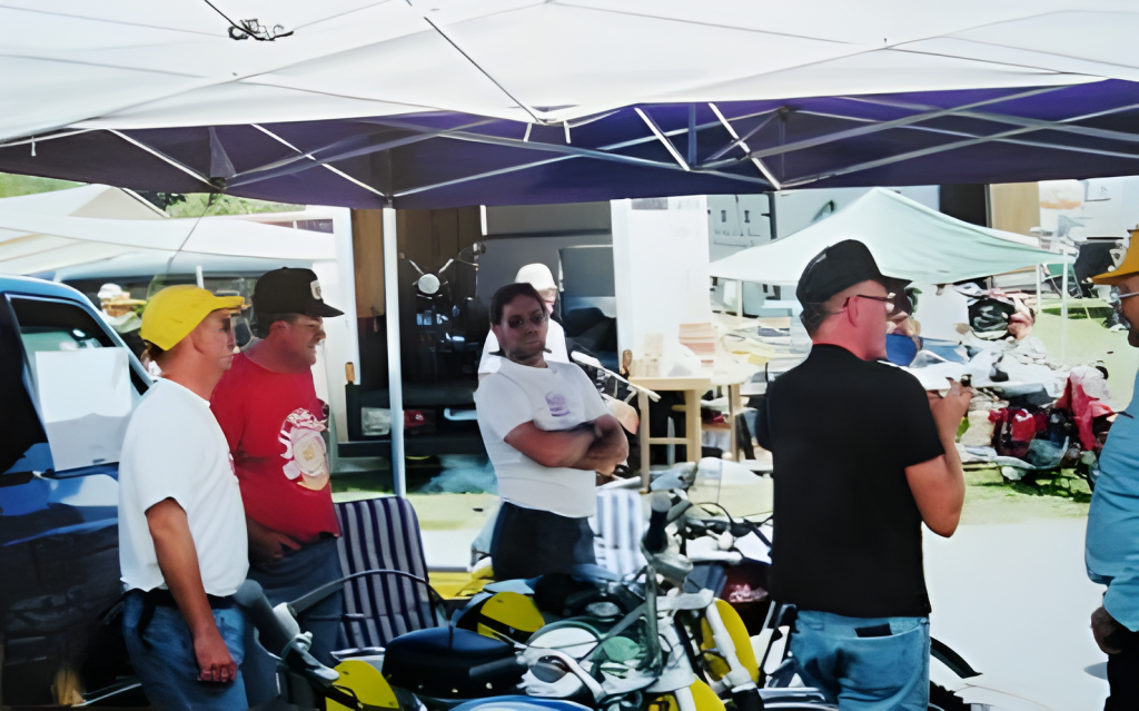 Group discussing under a canopy at outdoor event