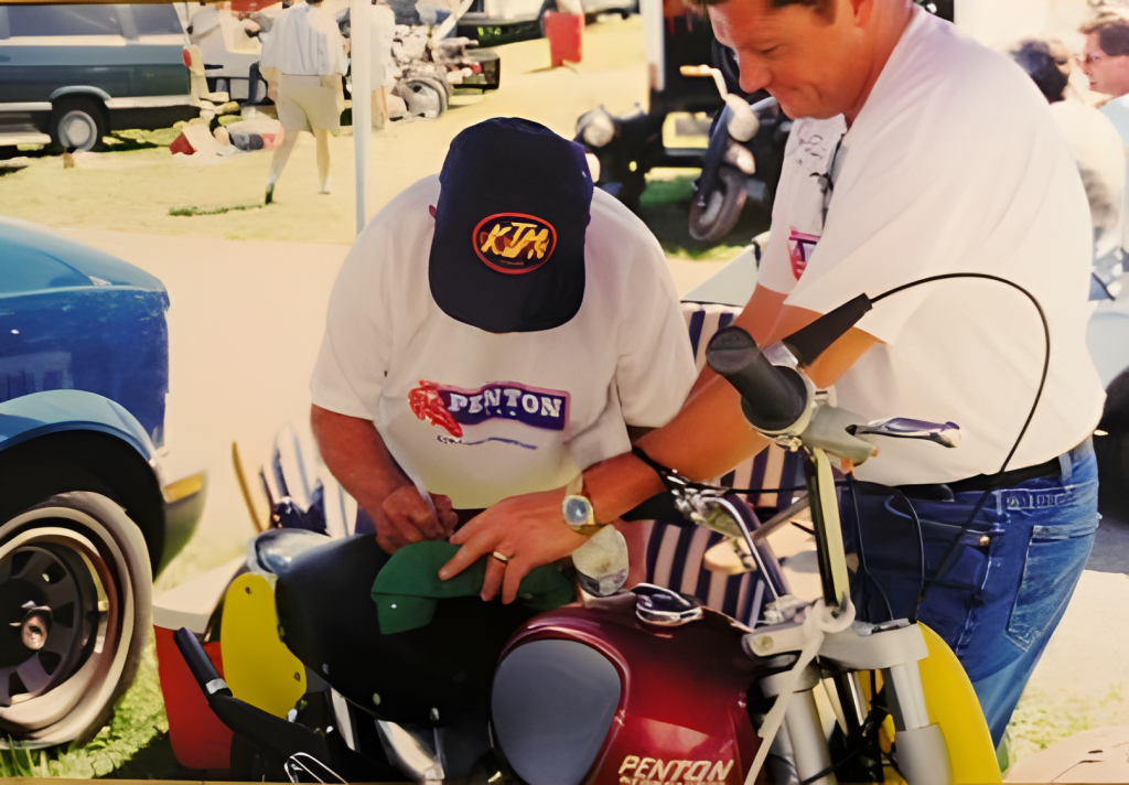 Two men working on vintage motorcycle