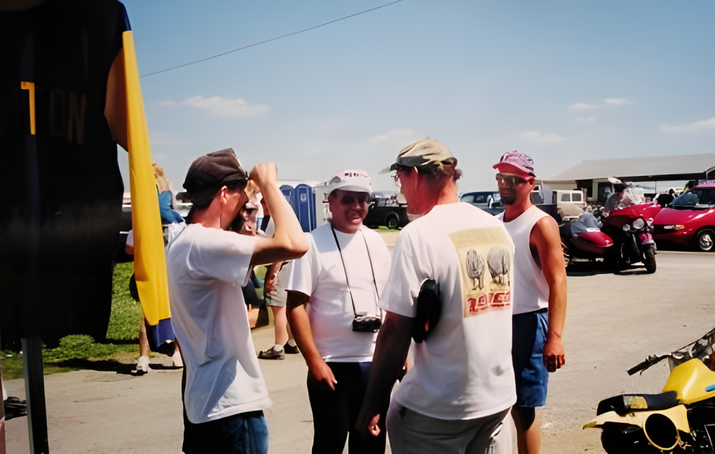 Group of people talking outdoors at an event.