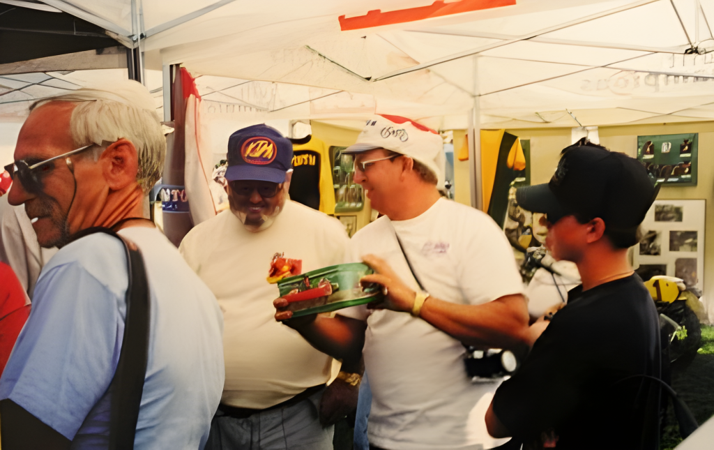 Men at a market booth exchanging items