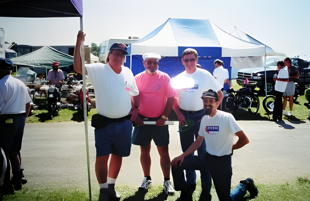 Group of four men at outdoor event.