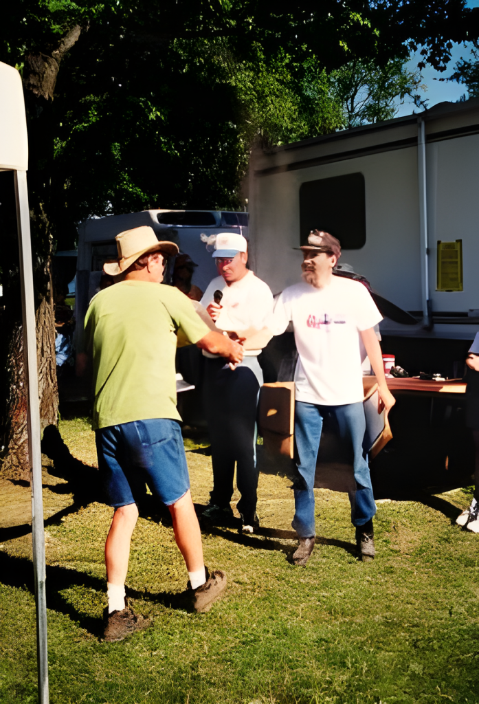 Men greeting outdoors by camper