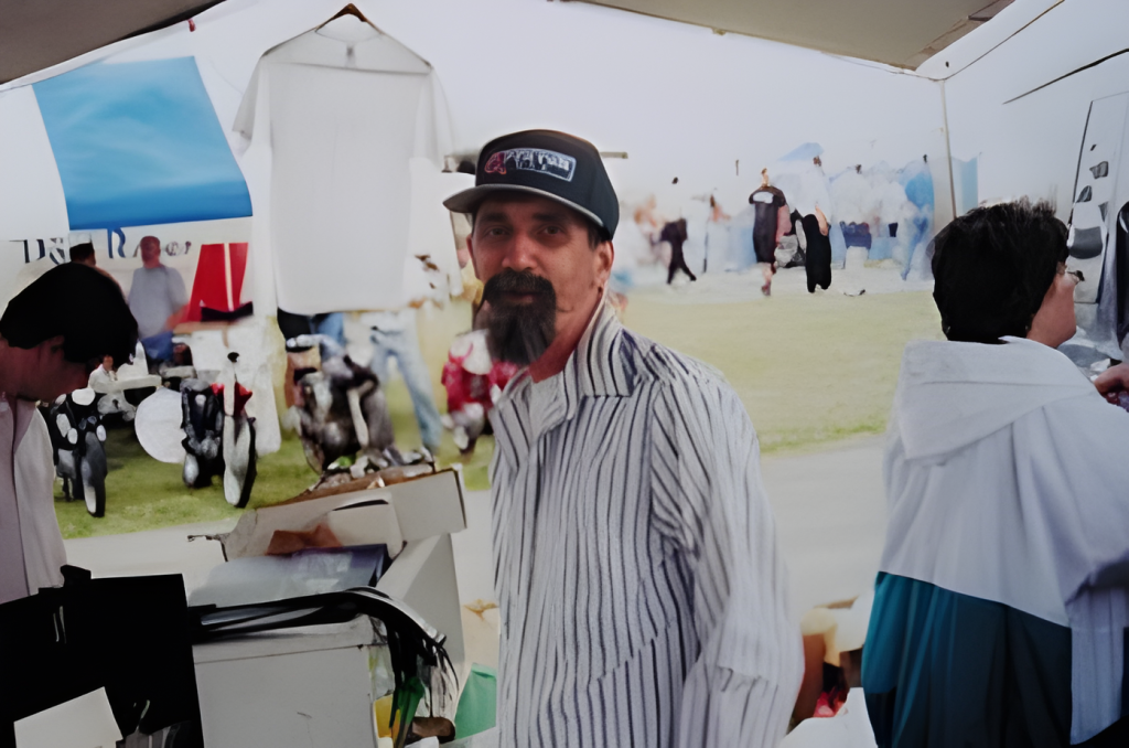 Man in striped shirt at outdoor event
