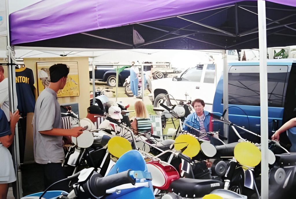 Market stall with scooters and visitors.