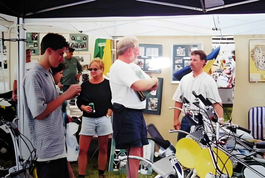 People discussing in a booth with bicycles.