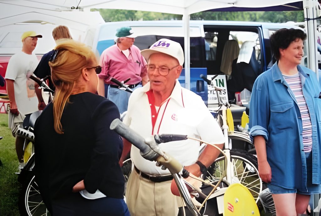 Group gathering at outdoor event with bicycles.