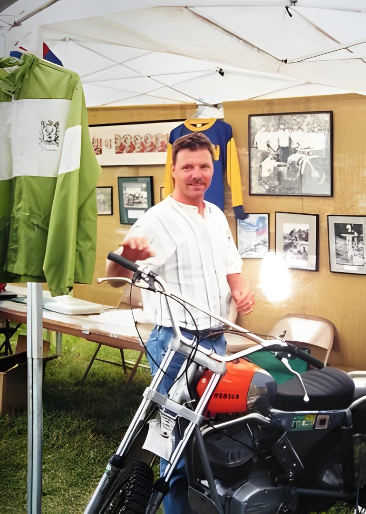 Man in vintage booth with motorcycle display