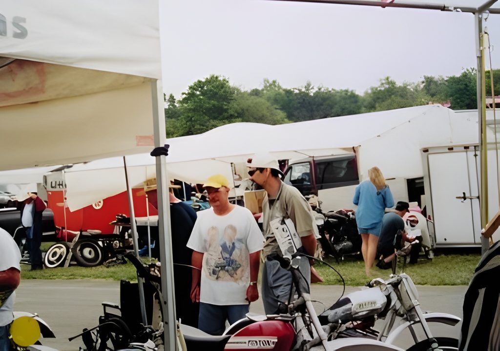 People at outdoor market with motorcycles