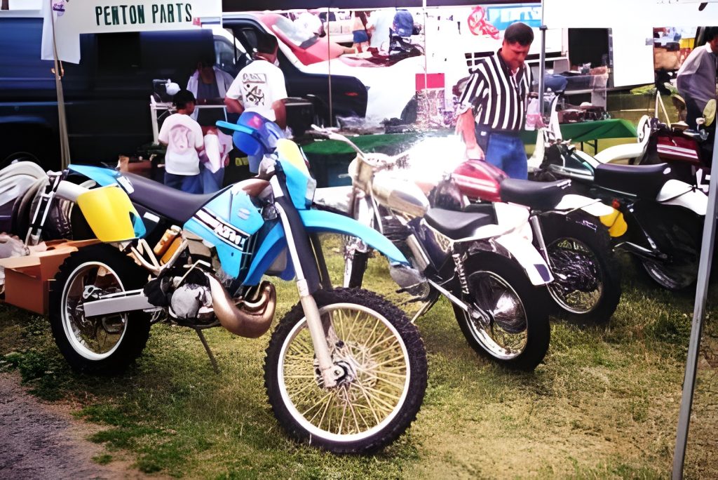 Motorcycles on display at outdoor parts market.