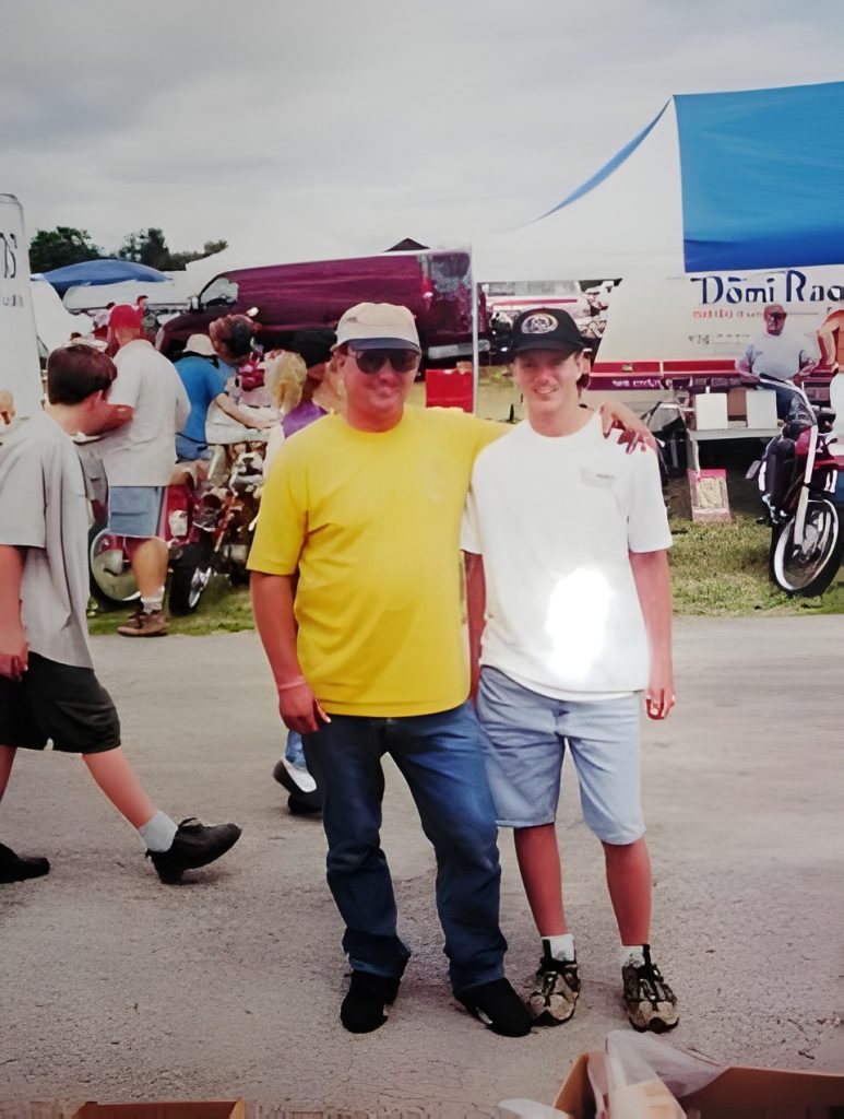 Two people posing at an outdoor event.