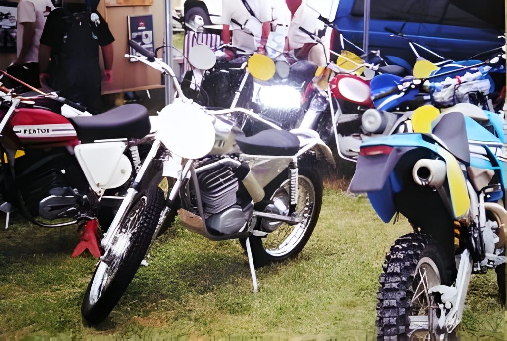 Vintage motorcycles displayed outdoors on grass