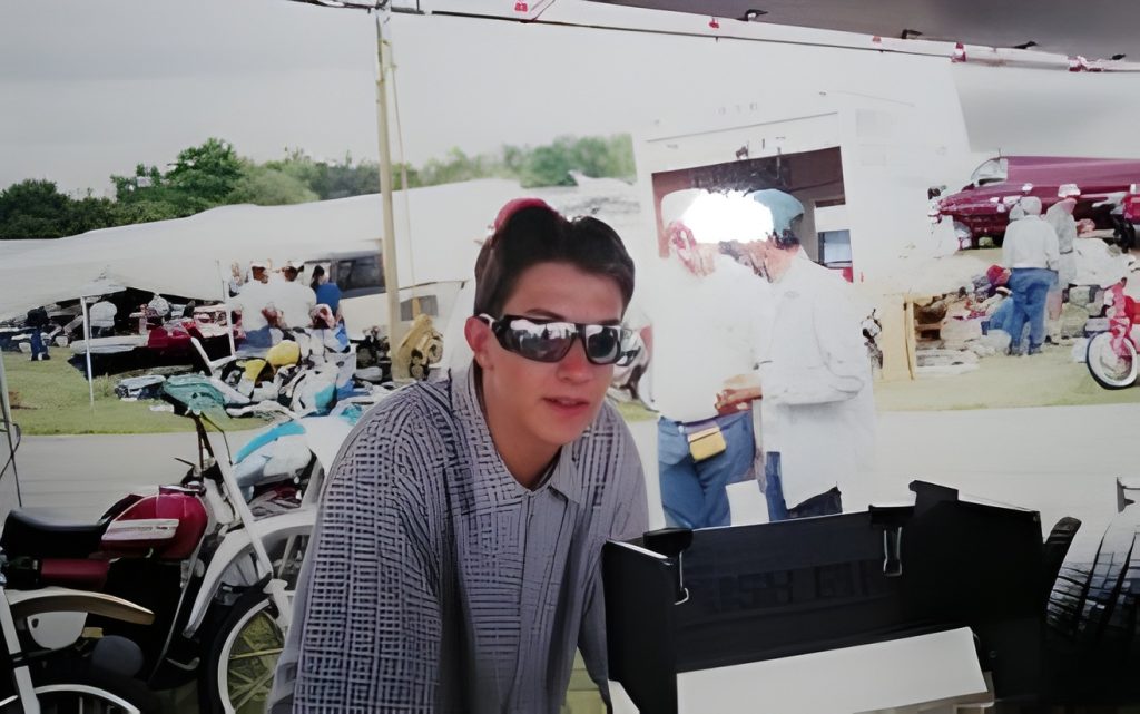 Person with sunglasses at outdoor market.