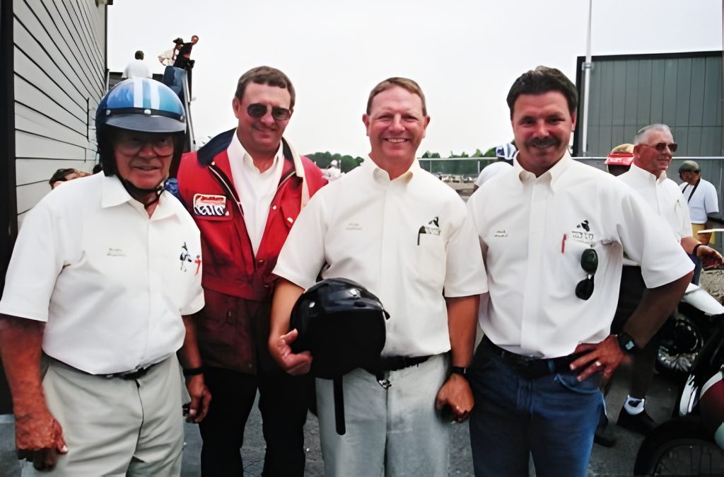 Group of men posing at race event track
