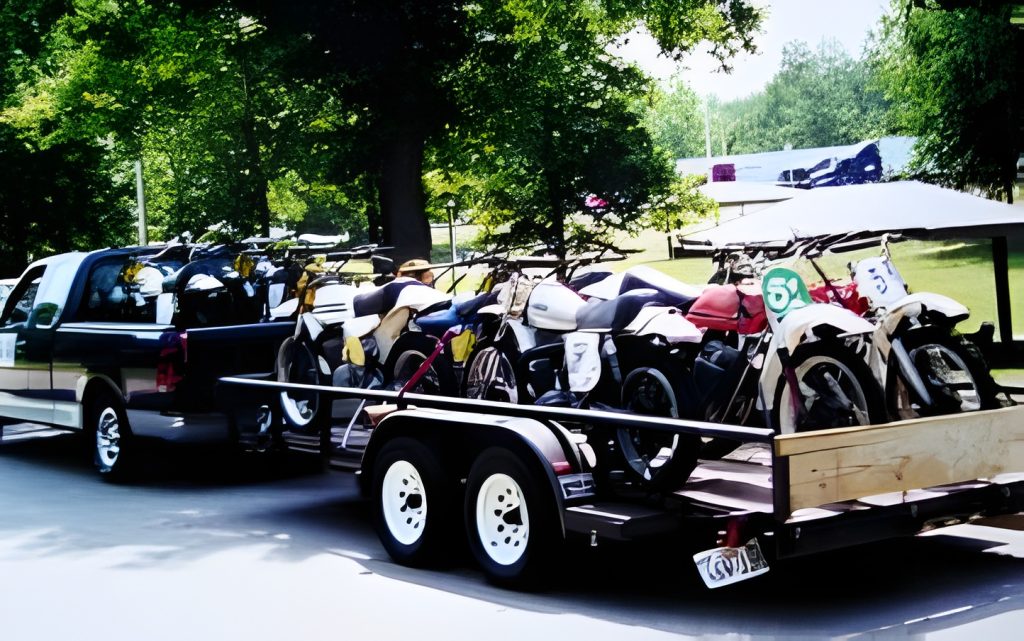 Truck towing trailer with multiple parked motorcycles.
