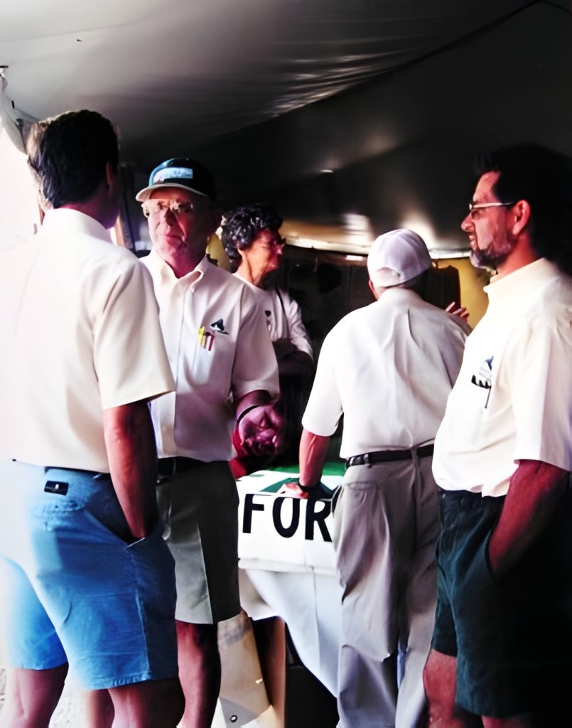 Group of men talking at an event.