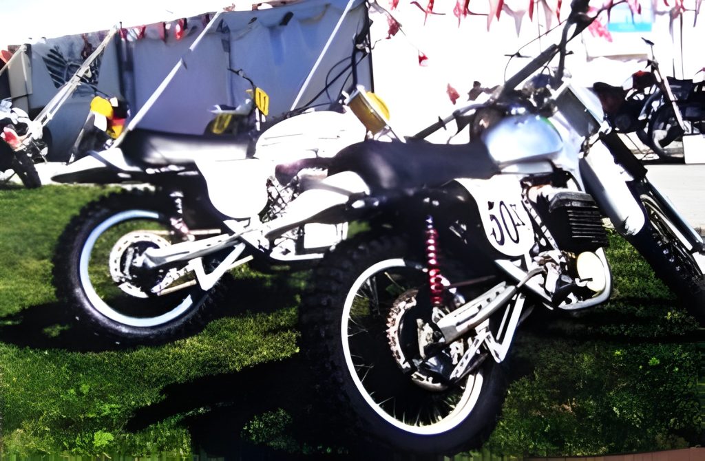 Two dirt bikes parked on grass