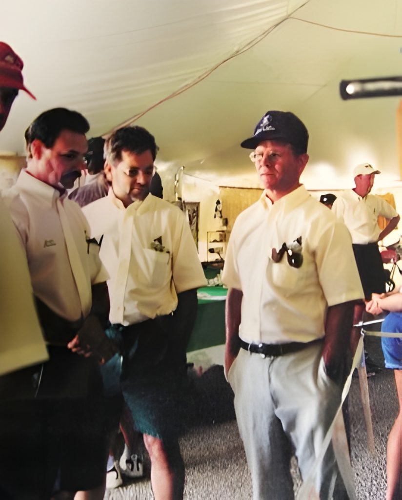 Group of people in tent with white shirts.