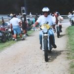 Person riding dirt bike on a track.