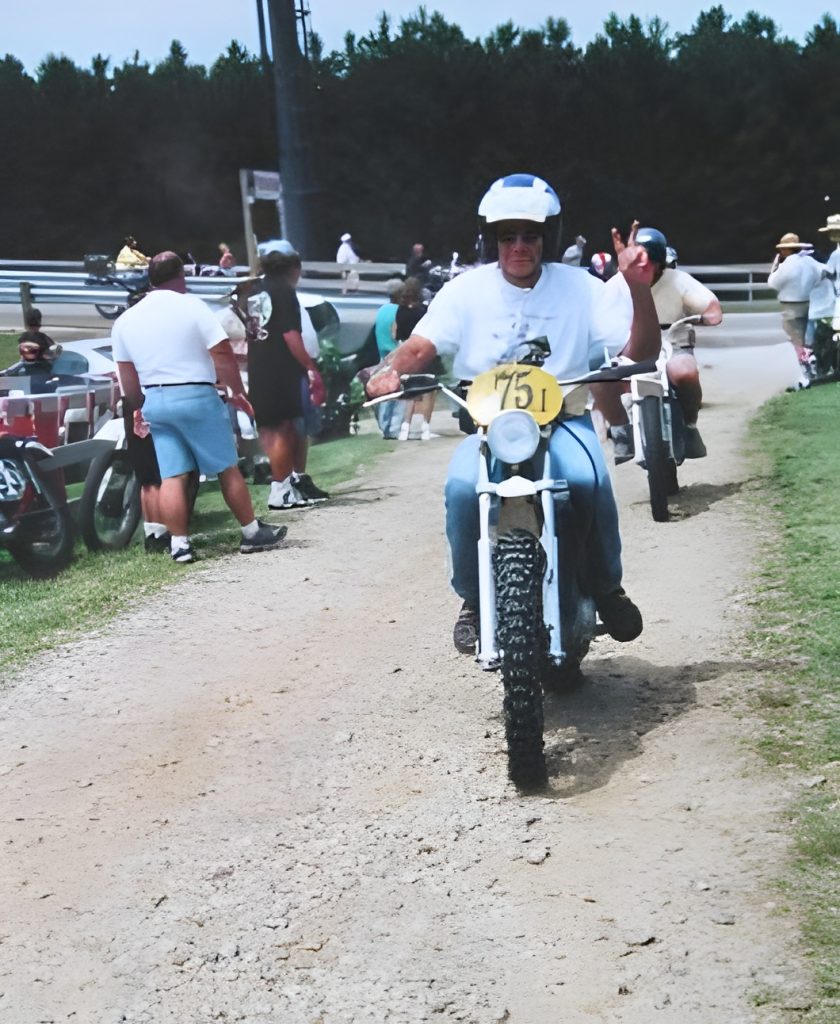 Person riding dirt bike on a track.