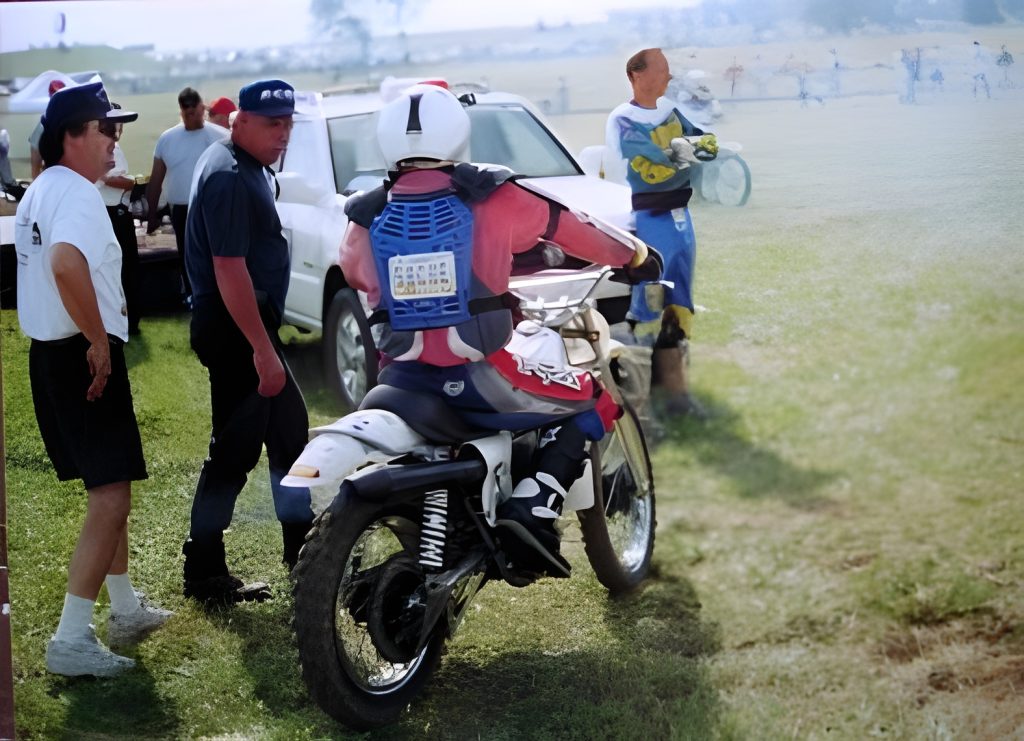 Motorcyclist with team discussing race strategy