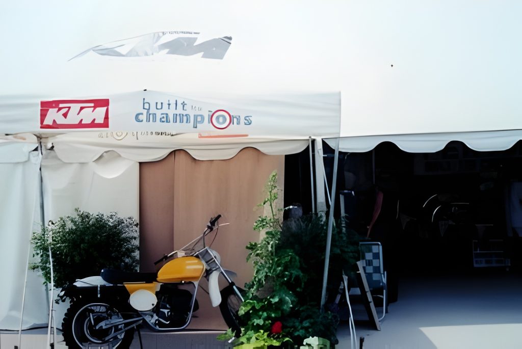 Vintage yellow motorcycle under a tent canopy