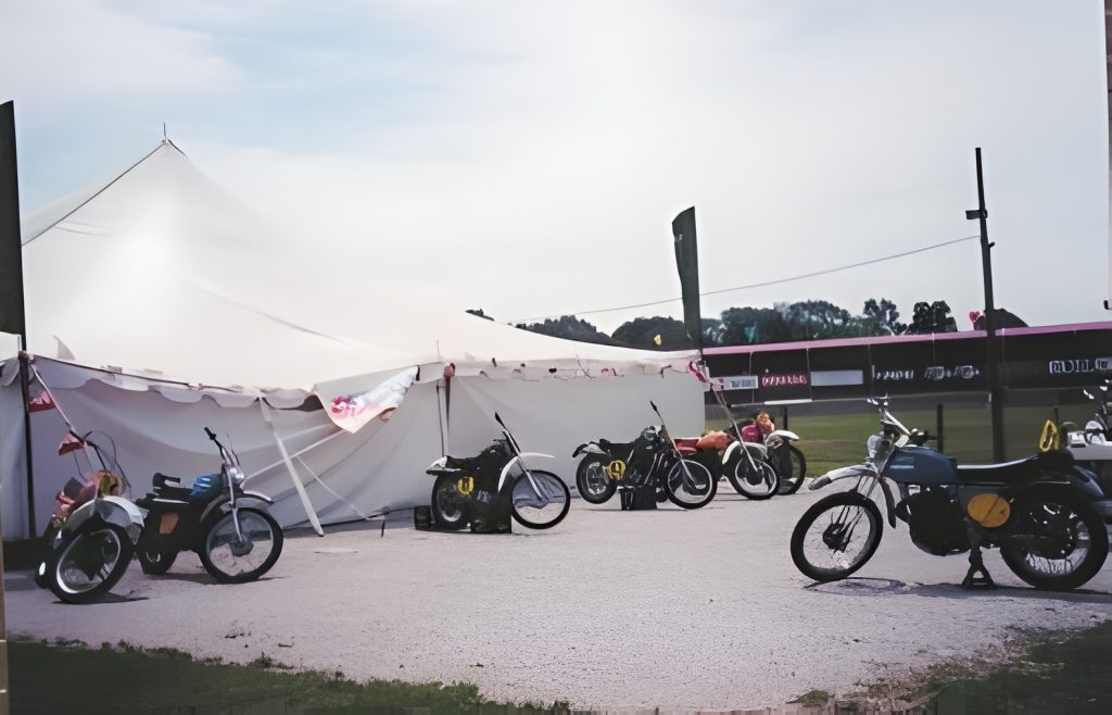 Vintage motorcycles outside a large white tent