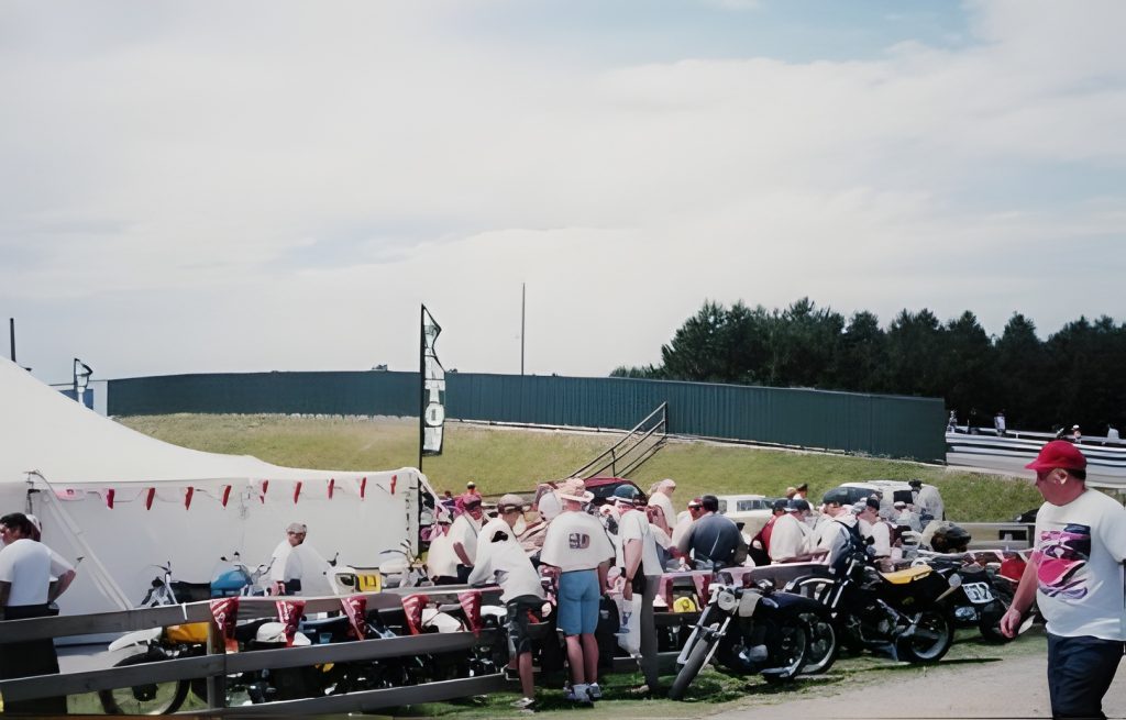 Group gathered at outdoor motorcycle event.
