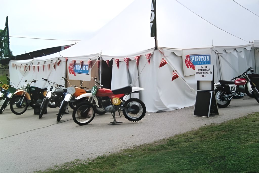 Motorcycles displayed outside a large white tent