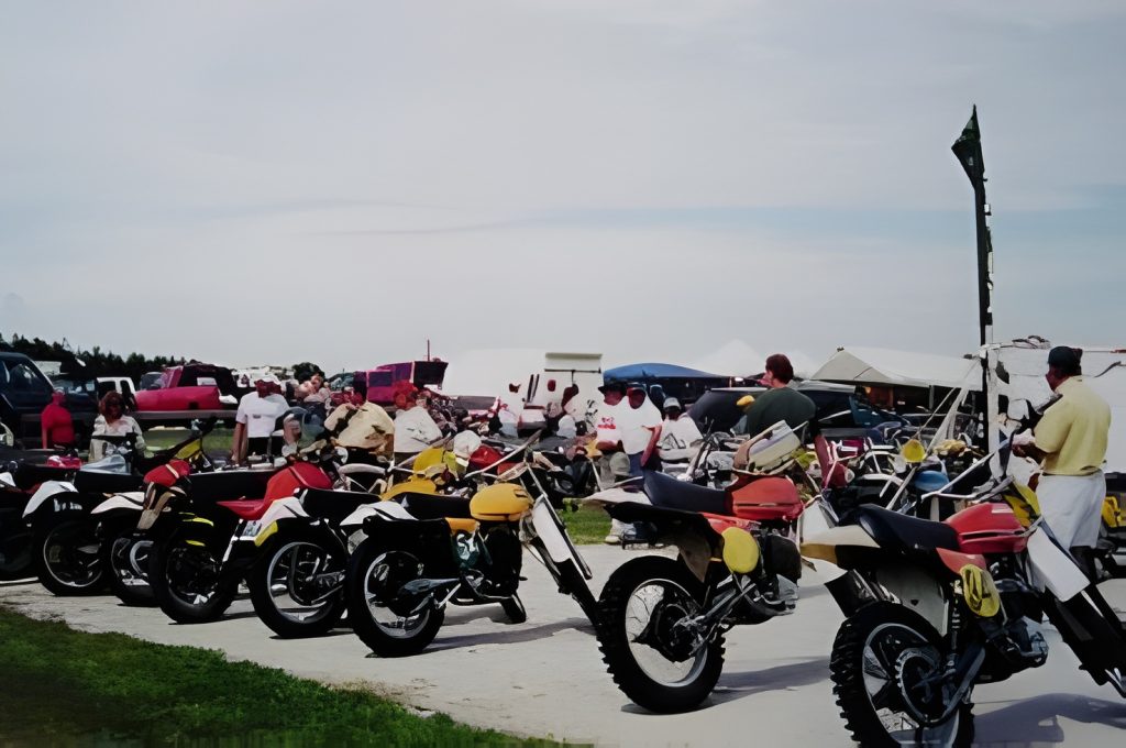 Dirt bikes displayed at outdoor motorcycle event