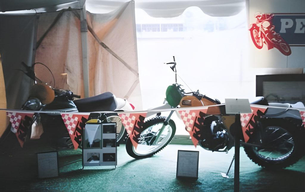 Vintage motorcycles on display at an exhibition tent.