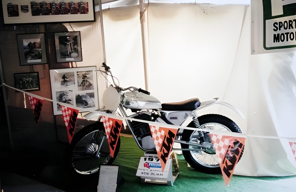 Vintage motocross bike on display with banners.