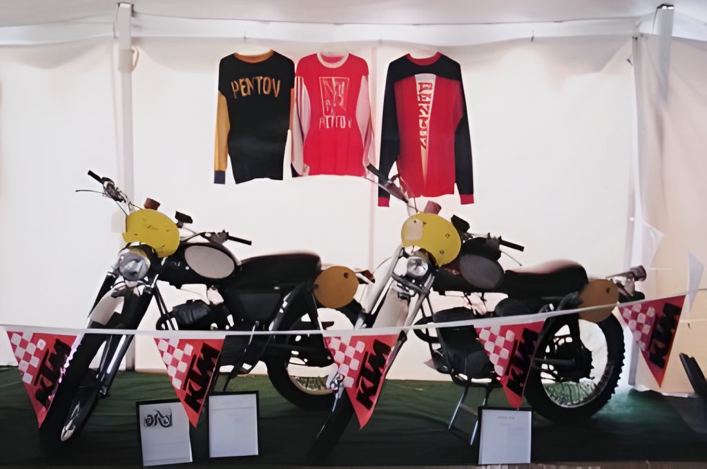 Vintage motorcycles and jerseys on display.