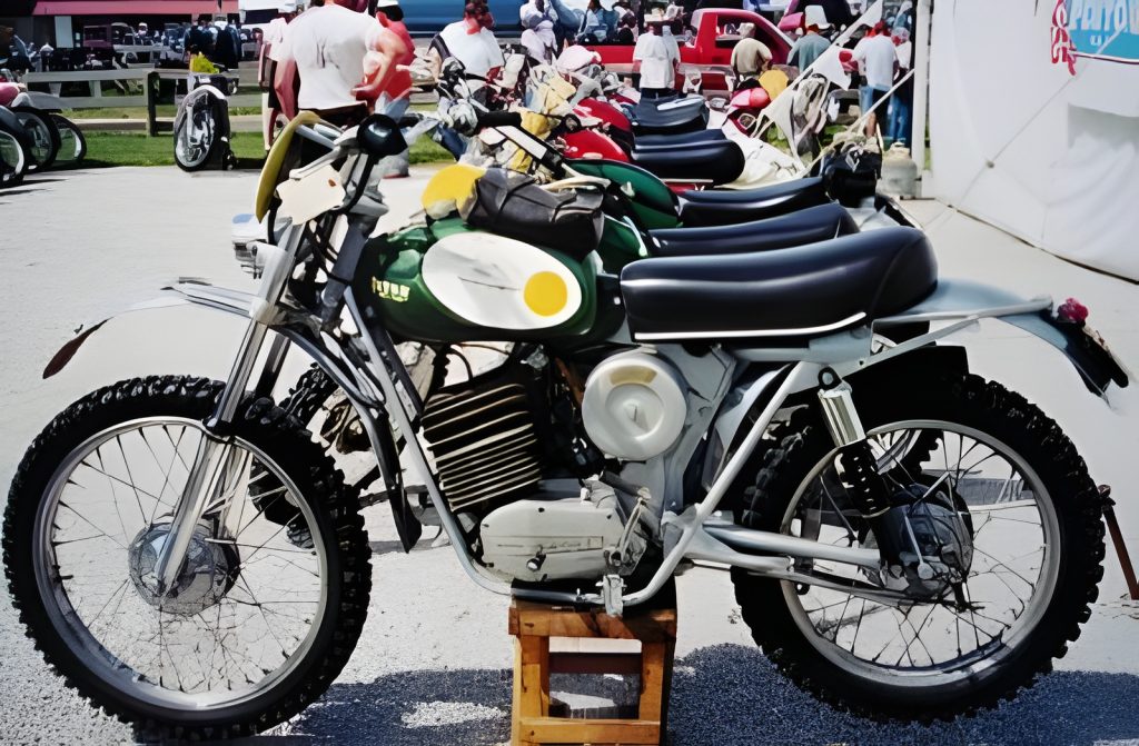 Vintage motorcycles lined up at outdoor event