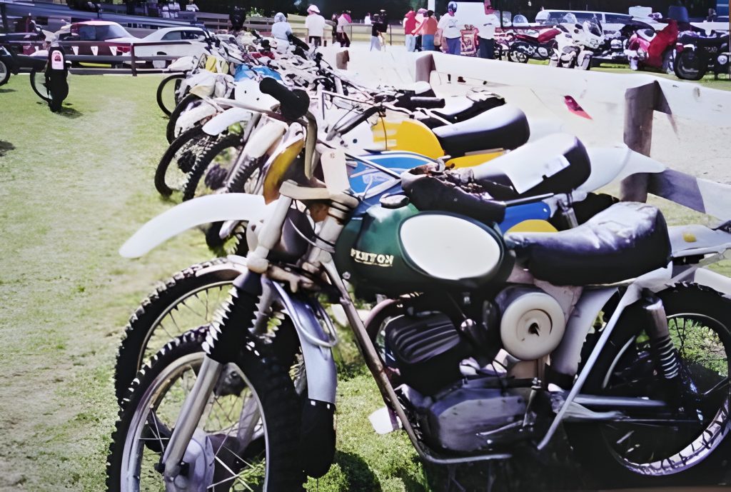Vintage motorcycles parked on grass field