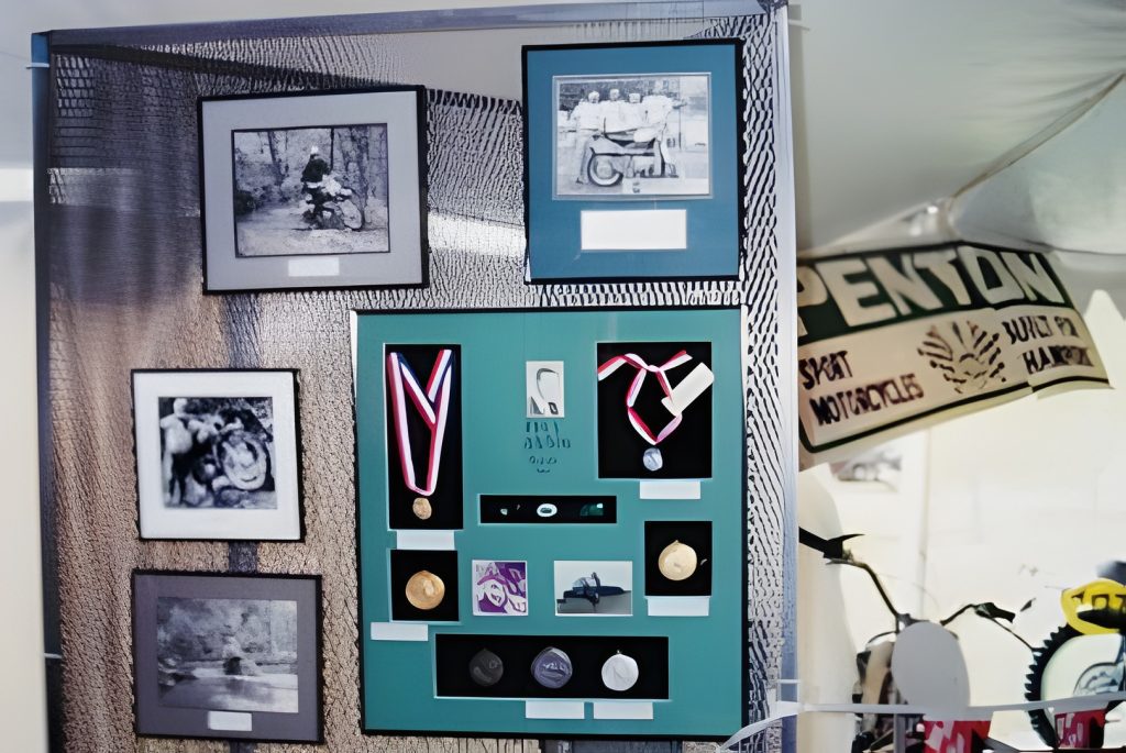 Display of framed medals and vintage photographs.