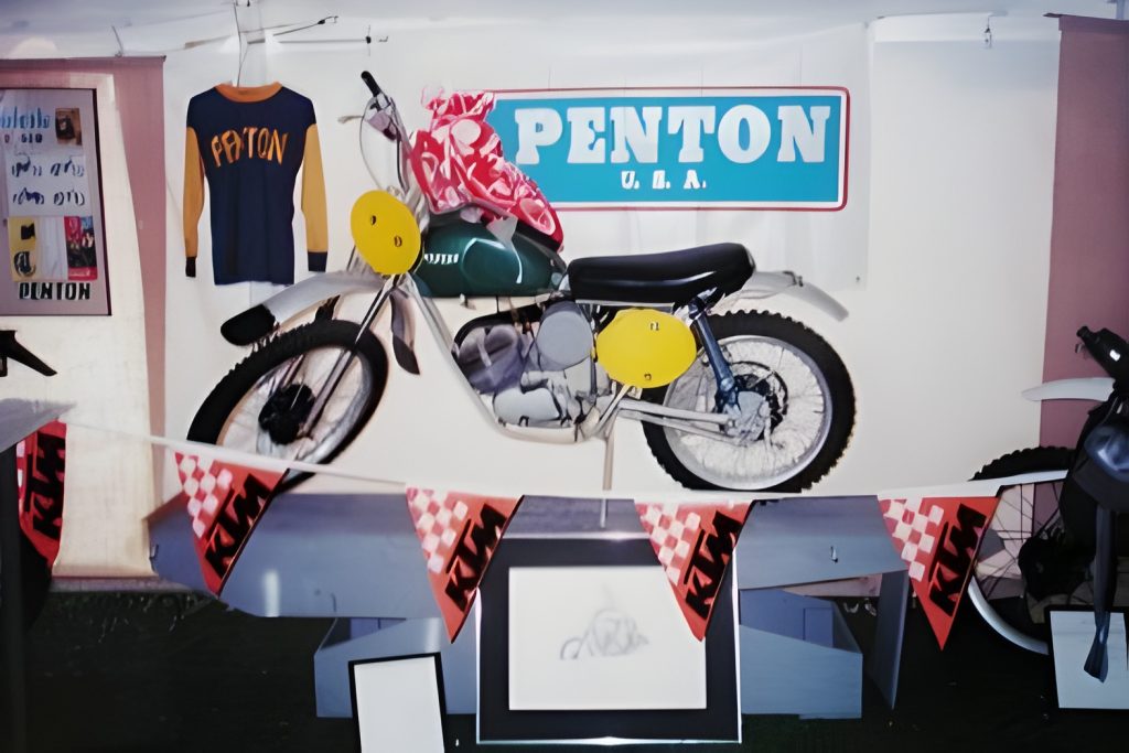 Vintage Penton motorcycle display with shirt and banner.